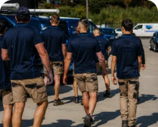 Plumbers walking to their service vans on a Ashfield job